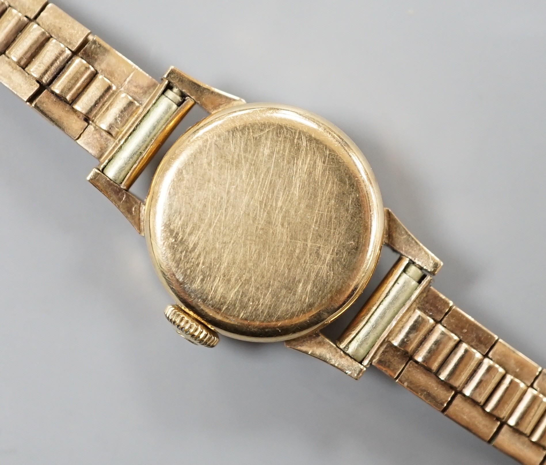 A lady's 9ct Omega manual wind wrist watch, on a 9ct gold bracelet